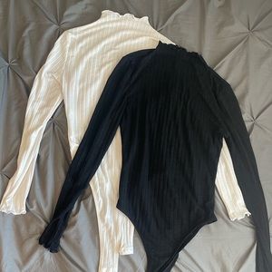 A black and white set turtleneck bodysuits